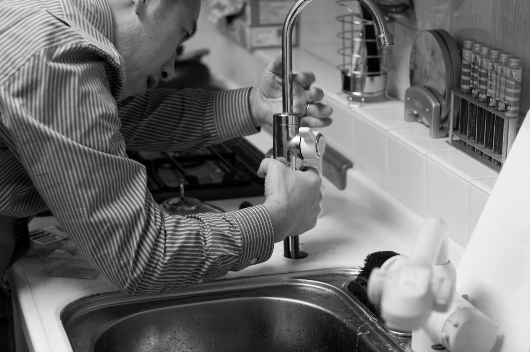 Plumber Repairing a Sink